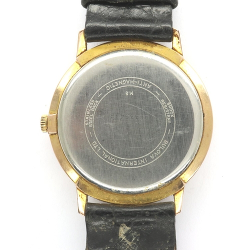 129 - BULOVA: gents gold plated manual wind wristwatch, with circular champagne dial, baton chapters and b... 