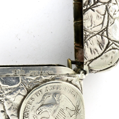 172 - Sterling silver vesta case embossed with an American silver half dollar, a quarter dollar and silver... 