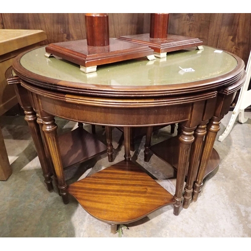 1502 - Circular table with green leather top and four enacting tables to lower. Not available for in-house ... 