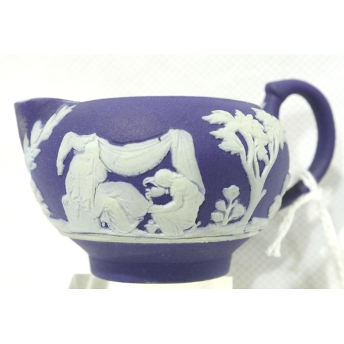 1130 - Miniature Wedgwood Jasperware jug, H: 20 mm, dark blue background with applied white figures. P&P Gr... 