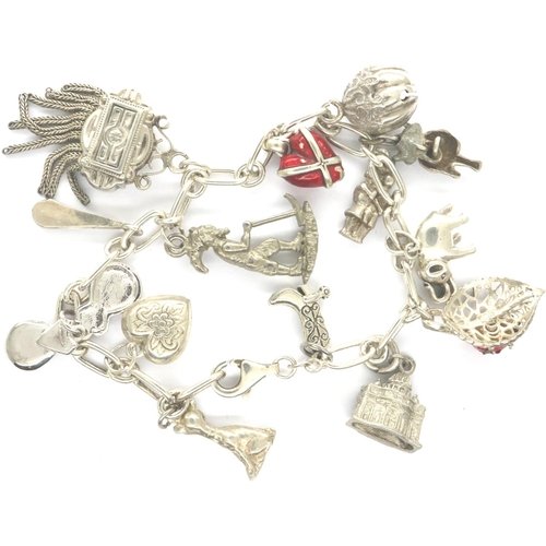 33 - 925 silver bracelet with fourteen charms, L: 18 cm. P&P Group 1 (£14+VAT for the first lot and £1+VA... 