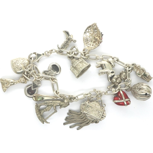 33 - 925 silver bracelet with fourteen charms, L: 18 cm. P&P Group 1 (£14+VAT for the first lot and £1+VA... 