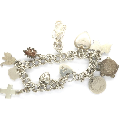 53 - Hallmarked silver charm bracelet with ten charms and hallmarked silver padlock clasp, 30g, L: 20 cm.... 