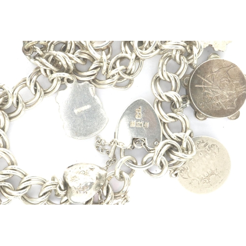 53 - Hallmarked silver charm bracelet with ten charms and hallmarked silver padlock clasp, 30g, L: 20 cm.... 