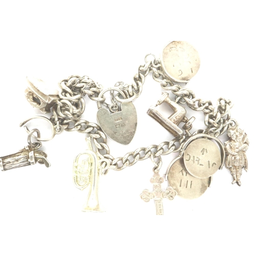 75 - Hallmarked silver charm bracelet with nine charms and hallmarked clasp and safety chain, L: 18 cm, 2... 