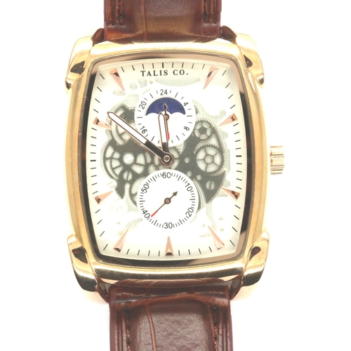 98 - Talis Co: Boxed gents wristwatch with visible escapement and two subsidiary dials on a brown leather... 