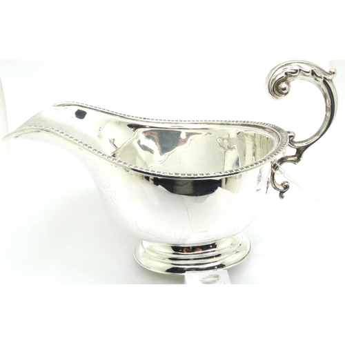 107 - Richard Woodman Bunbridge for Harrods, an Edward VIII hallmarked silver sauce boat, L: 16 cm, 95g. P... 