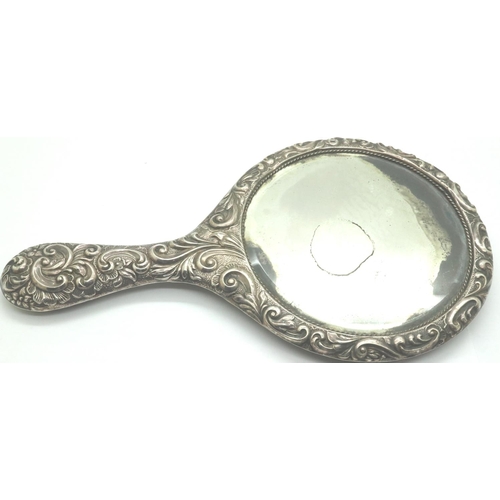 109 - Hallmarked silver hand mirror with floral decoration, Chester assay, H: 29 cm. P&P Group 2 (£18+VAT ... 