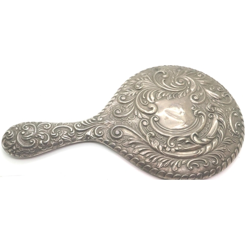 109 - Hallmarked silver hand mirror with floral decoration, Chester assay, H: 29 cm. P&P Group 2 (£18+VAT ... 