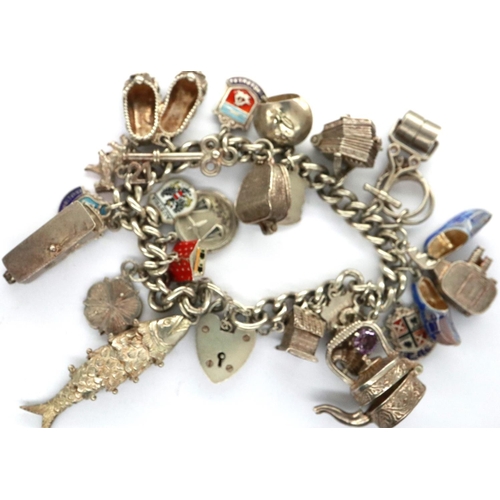 81 - Silver charm bracelet with twenty charms, 93g. P&P Group 1 (£14+VAT for the first lot and £1+VAT for... 