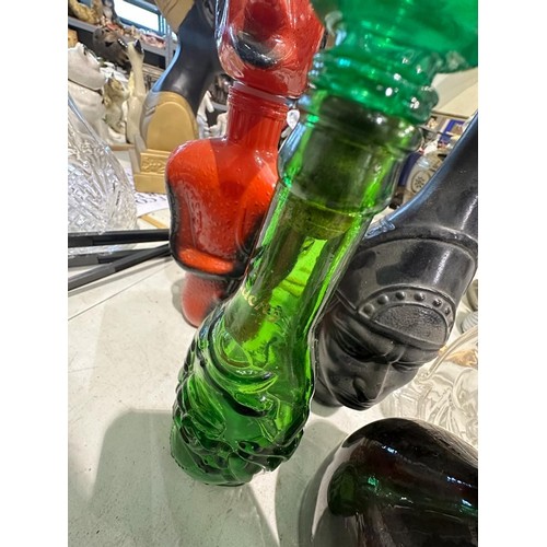 1351 - Six spirit decanters in the forms of devils, Buddha etc. Minor losses to poison bottle, others appea... 