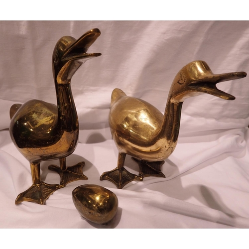 Pair of brass door stops , largest H 20 cm, and a decorative brass egg