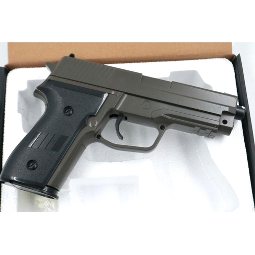 2021 - New old stock airsoft pistol, model V12 in brown, boxed. P&P Group 2 (£18+VAT for the first lot and ... 