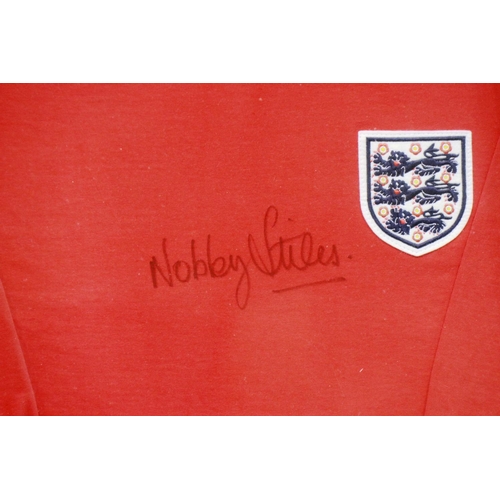 2056 - Nobby Styles signed England shirt. Excluding frame: P&P Group 1 (£14+VAT for the first lot and £1+VA... 