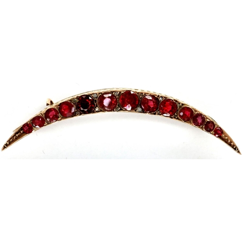 7 - Victorian 9ct rose gold crescent brooch, set with thirteen graduated red stones, L: 50 mm, 2.9g. P&P... 