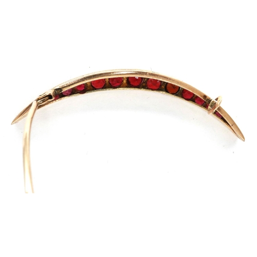 7 - Victorian 9ct rose gold crescent brooch, set with thirteen graduated red stones, L: 50 mm, 2.9g. P&P... 