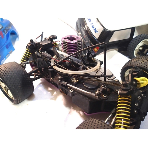 2111 - Two radio control cars, Tamiya electric buggy and IC engine chassis, plus two bodyshells. P&P Group ... 