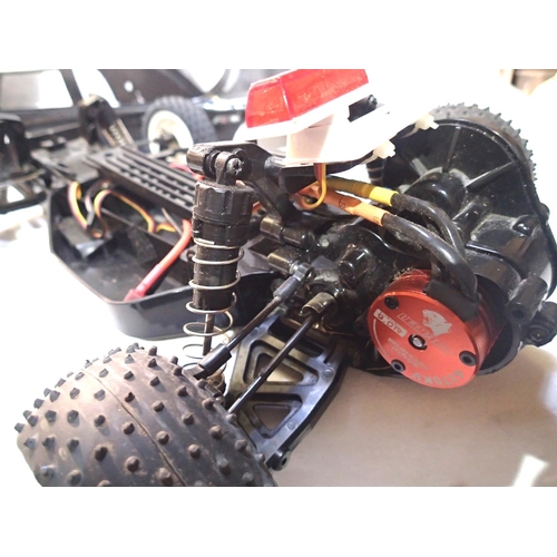 2111 - Two radio control cars, Tamiya electric buggy and IC engine chassis, plus two bodyshells. P&P Group ... 