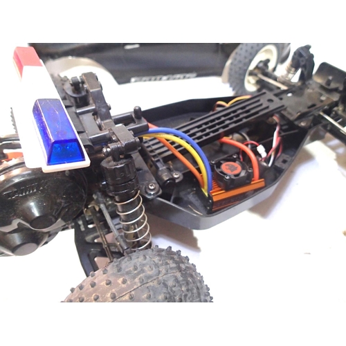 2111 - Two radio control cars, Tamiya electric buggy and IC engine chassis, plus two bodyshells. P&P Group ... 