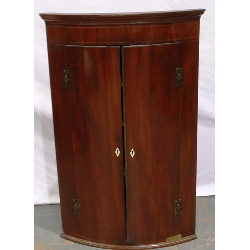 2144 - A George III walnut wall hanging corner cupboard, barrel front with three interior shelves, W: 76 cm... 