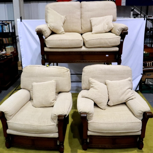 2149 - A modern oak framed lounge suite, each frame carved with linenfold decoration, upholstered in cream ... 