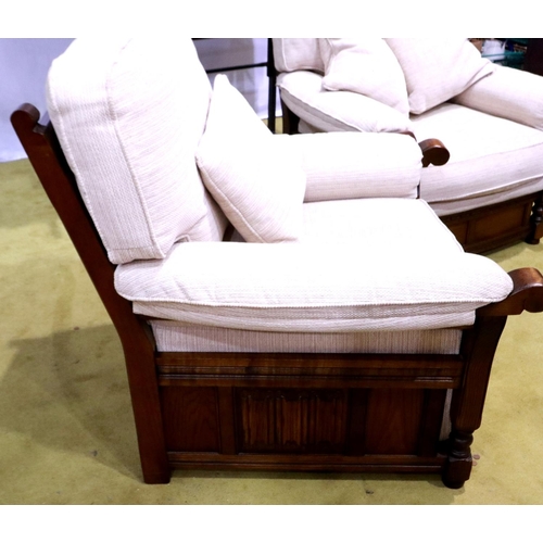 2149 - A modern oak framed lounge suite, each frame carved with linenfold decoration, upholstered in cream ... 