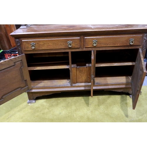 2153 - A Victorian mahogany mirror-back dresser, with carved and panelled doors, two drawers and bevelled g... 