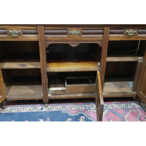 2154 - A late 19th century oak dresser, with mirrored upstand, above a sideboard base of cupboards and draw... 