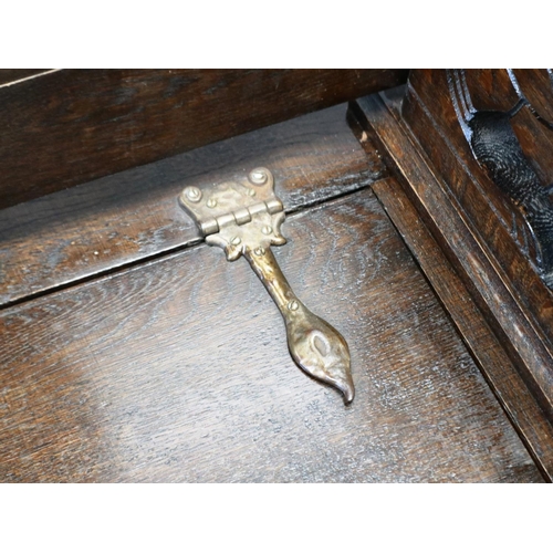 2157 - An early 20th century oak Monks bench, with hinged seat and carved arm rails, 89 x 45 x 77 cm H. Not... 