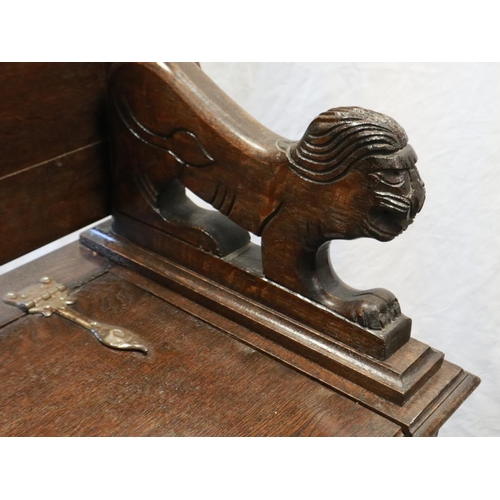 2157 - An early 20th century oak Monks bench, with hinged seat and carved arm rails, 89 x 45 x 77 cm H. Not... 