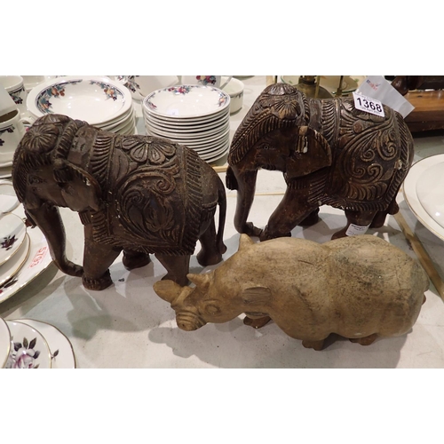 1368 - Two wooden carved elephants and a rhino, H: 21 cm. P&P Group 3 (£25+VAT for the first lot and £5+VAT... 