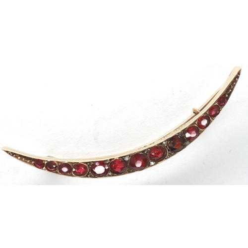 43 - Victorian 9ct rose gold crescent brooch, set with thirteen graduated red stones, L: 50 mm, 2.9g. P&P... 