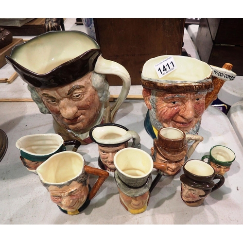 1411 - Selection of Carlton jugs including a Royal Doulton Sam Johnson example. Not available for in-house ... 