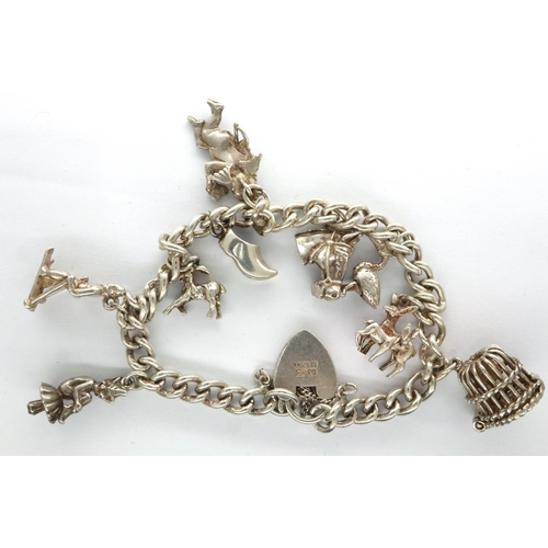 10 - Hallmarked silver charm bracelet with nine 925 silver charms, and hallmarked silver clasp, L: 18 cm,... 