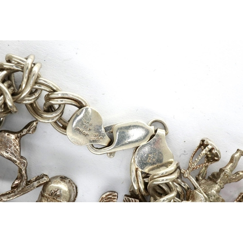 19 - 925 silver charm bracelet with thirteen charms, L: 18 cm. P&P Group 1 (£14+VAT for the first lot and... 