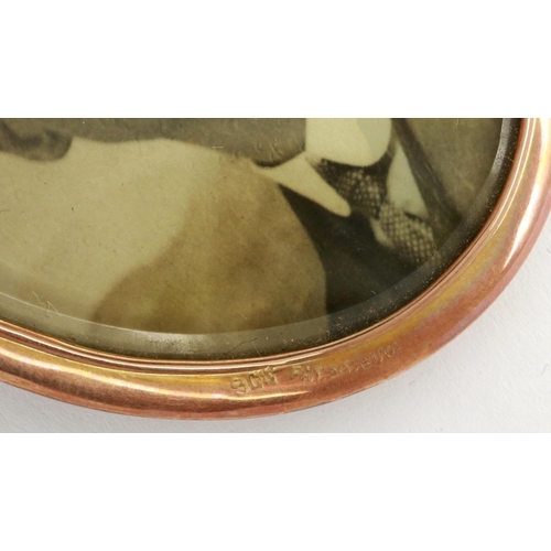 73 - Large 9ct gold bound double sided photograph pendant, H: 70 mm. P&P Group 1 (£14+VAT for the first l... 