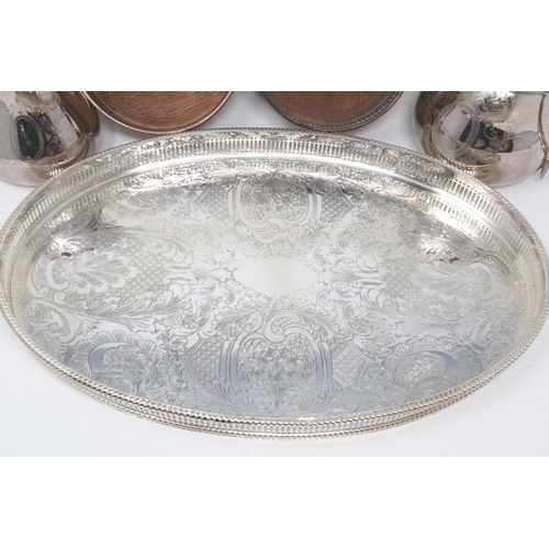 110 - An oval silver plated galleried tray, two plated wine bottle coasters and a Walker & Hall cream and ... 