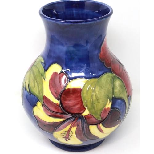 239 - Moorcroft vase in the Hibiscus pattern, H: 25 cm, crack to neck and slight chip to paint. P&P Group ... 