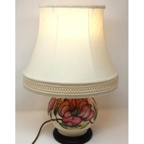 243 - Moorcroft table lamp in the Magnolia pattern, with shade, overall H: 57 cm, crazing throughout. P&P ... 