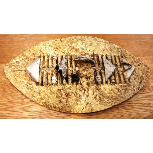 281 - African tribal hide bound shield, L: 70 cm. P&P Group 2 (£18+VAT for the first lot and £3+VAT for su... 