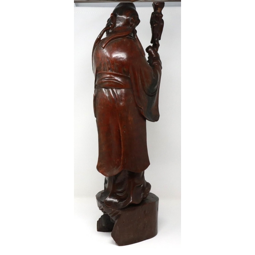 288 - Carved hardwood statue of Shou Lao (Shou Xing) Taoist God of Longevity, standing on a bat, H: 60 cm.... 