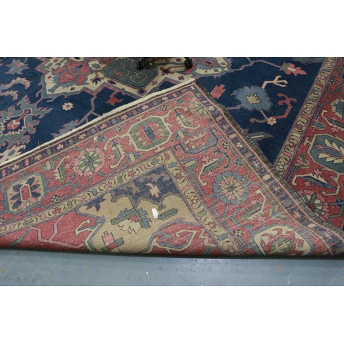 379 - Very large red ground rug with polychrome geometric design, 500 x 440 cm. Not available for in-house... 