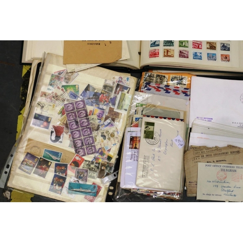 423 - Two stamp albums containing British and worldwide stamps together with a quantity of loose stamps an... 