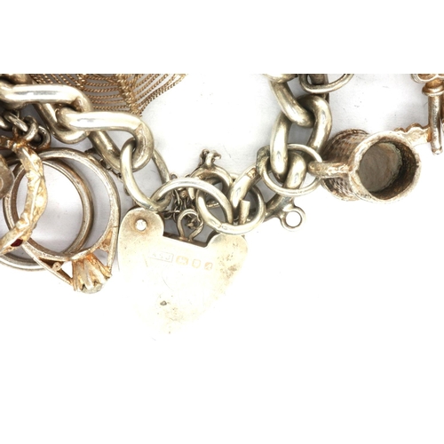 21 - Hallmarked silver charm bracelet, with 925 silver charms, L: 18 cm, 89g. P&P Group 1 (£14+VAT for th... 