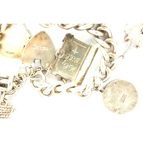 29 - Hallmarked silver charm bracelet with ten charms and a hallmarked silver padlock clasp, L: 18 cm, 68... 