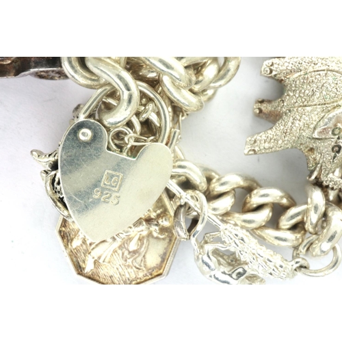 3 - 925 silver charm bracelet with nine charms, padlock clasp and safety chain, together with two dog fo... 