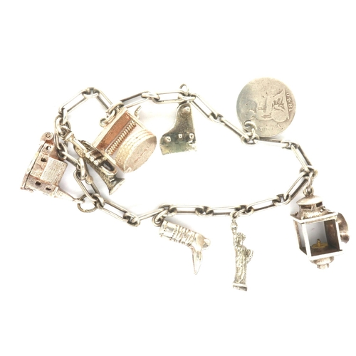 41 - 925 silver charm bracelet with eight charms, L: 18 cm. P&P Group 1 (£14+VAT for the first lot and £1... 