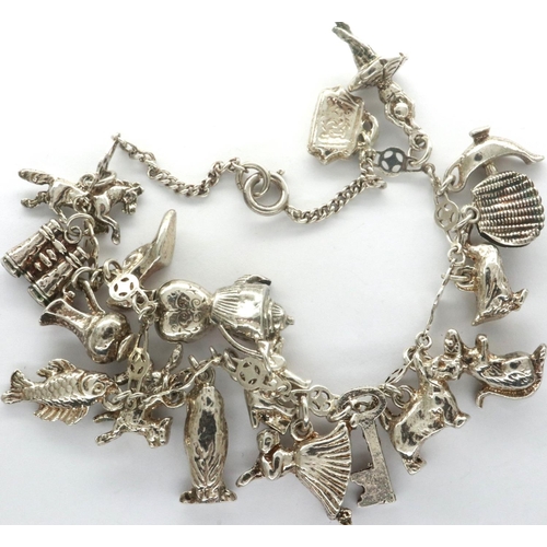 17 - Silver charm bracelet with nineteen charms, 49.2g. P&P Group 1 (£14+VAT for the first lot and £1+VAT... 