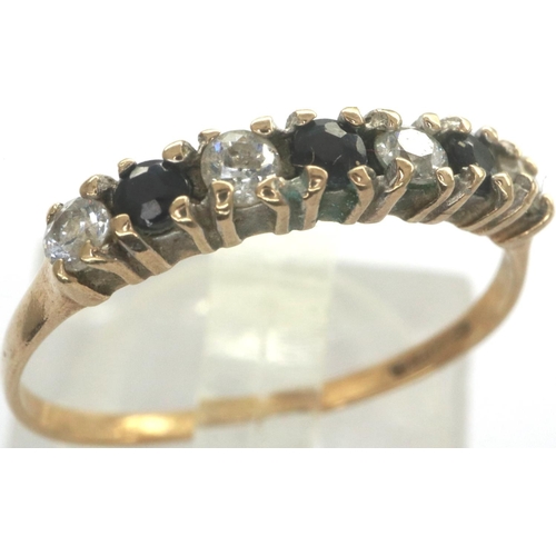 33 - 9ct gold ring with sapphires and four Cubic Zirconia stones, size N, 1.1g. P&P Group 1 (£14+VAT for ... 