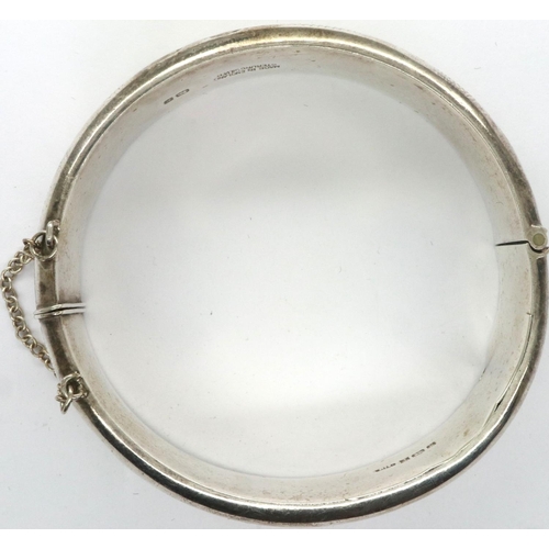 73 - Hallmarked silver snap bangle with safety chain, D: 65 mm, 23g, slight dent to silver. P&P Group 1 (... 
